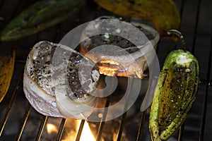 Filet Mignon and peppers roasting on an open flame barbque pit. photo