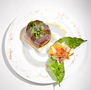 Filet mignon prepared with bacon and accompanied by a polenta purÃ©e