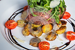 Filet mignon Steak with salad and tomatoes and garlics