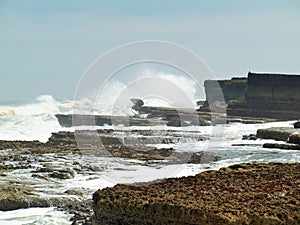 Filey brig waves crashing onto the rocks.