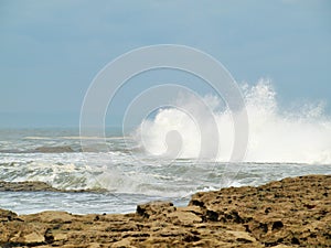Filey brig waves crashing onto the rocks.