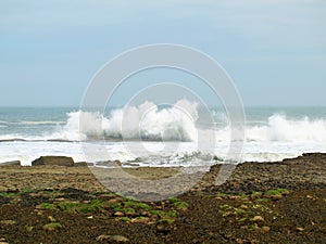 Filey brig waves crashing over the rocks