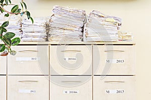Filing cabinet and a stack of old papers
