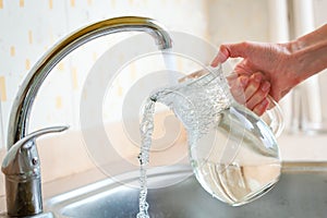 Filing glass pitcher with water