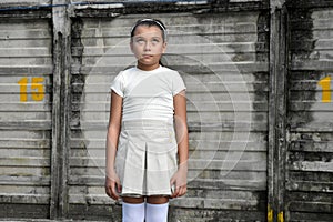 Filipina Girl And Apathy Wearing Hair Band Near Wall