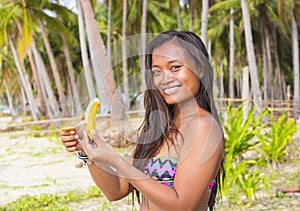 Filipina girl eating banana