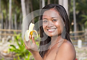 Filipina girl eating banana