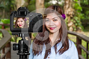 Filipina woman on a bridge in a garden