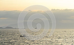 Filipino Banca boats being drenched by a midday rain