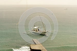 Filipino Banca boats being drenched by a midday rain