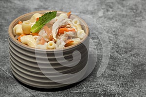 Filipino chicken sopas in ribbed bowl on a table. photo