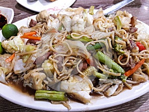Filipino dish, pancit canton, inspired by Chinese cuisine.