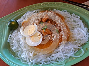 Filipino dish, pancit palabok, is a white noodle with eggs, and meat and chicharon in oarange sauce