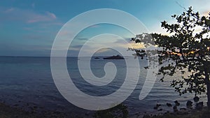 Filipino Fisherman Fishing At Sunset in evening time lapse seascape On Banka Outrigger Boat with Boat Traffic Off Scenic