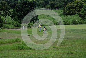 Filipino grass-cutters working in the field in the Philippines photo