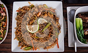 A Filipino noodle cuisine called pansit served together with the other dishes