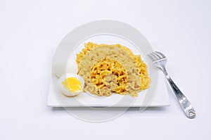 A Filipino Pancit Canton with boiled egg on a plate.