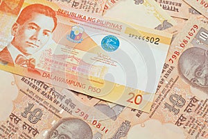 A Filipino piso bill with Indian ten rupee bank notes