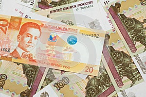 A Filipino piso billwith Russian one hundred ruble bills photo