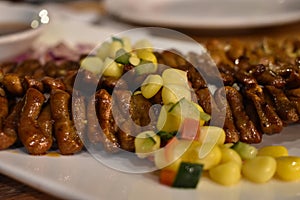 Filipino street food, `isaw`, is a grilled or barbecued chicken intestine