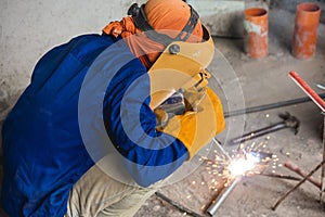 A Filipino welder or construction worker wearing protective gear.