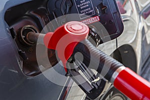 Fill the car with fuel. The car is filled with gasoline at a gas station. Gas station pump. Man refueling gasoline with fuel in a
