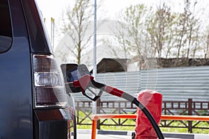 Fill the car with fuel. The car is filled with gasoline at a gas station. Gas station pump. Man refueling gasoline with fuel in a