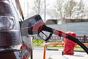 Fill the car with fuel. The car is filled with gasoline at a gas station. Gas station pump. Man refueling gasoline with fuel in a