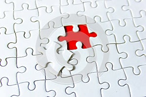 Fill the missing parts of hand white jigsaw concept puzzle for succeed