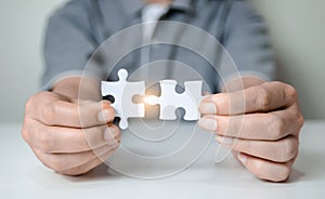 Fill the missing parts of hand white jigsaw concept puzzle for succeed