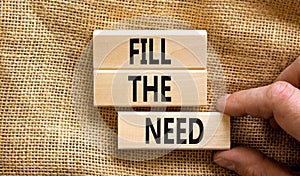 Fill the need symbol. Concept words Fill the need on wooden blocks on a beautiful canvas table canvas background. Businessman hand