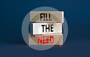 Fill the need symbol. Concept words Fill the need on wooden blocks on a beautiful grey table grey background. Business, finacial