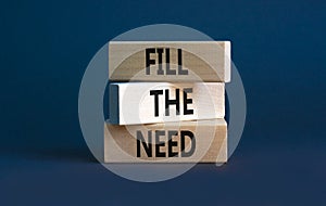 Fill the need symbol. Concept words Fill the need on wooden blocks on a beautiful grey table grey background. Business, finacial