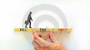 Fill the need symbol. Concept words Fill the need on wooden blocks on a beautiful white table white background. Businessman hand.