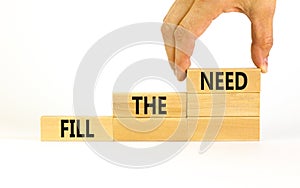 Fill the need symbol. Concept words Fill the need on wooden blocks on a beautiful white table white background. Businessman hand.