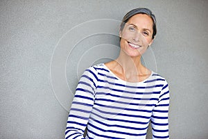 Fill your heart with whats important. Portrait of an attractive mature woman in casualwear standing against a gray wall.