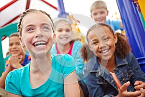 Filled with innocence and joy. A multi-ethnic group of happy children playing on a jungle gym in a play park.