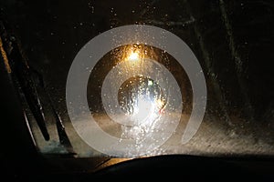 Filled with rain windshield of the car, poor visibiliy at night photo