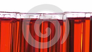 Filled test tubes with red liquid on a turntable