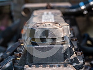 Filler cap for filling engine oil into a car engine.