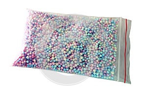 Filler for gift box, of color foam balls, in transparent bag with zip lock. isolated on white background