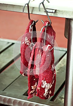 Fillet beef steak hanging in a butchery