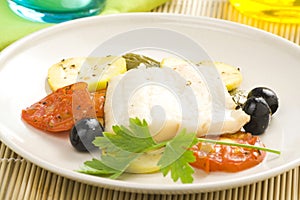 Fillet of cod baked tomatoes zucchini black olives