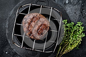 Fillet Mignon grilled beef Steak on a grill. Black background. Top view