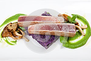 Fillet of tuna with purple potatoes, mushrooms and mushy peas