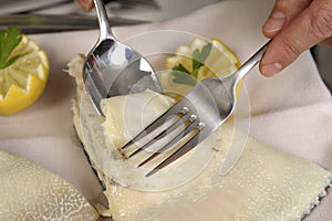 Filleting a poached turbot photo