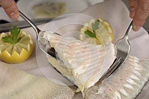 Filleting a poached turbot photo