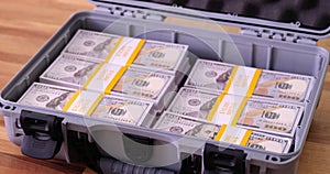 Filling case with dollars and piles of money