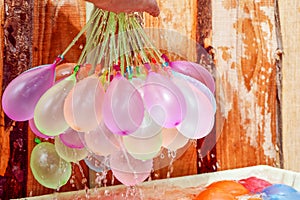 Filling colorful water balloons