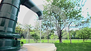 Filling the container with a water from the well pump